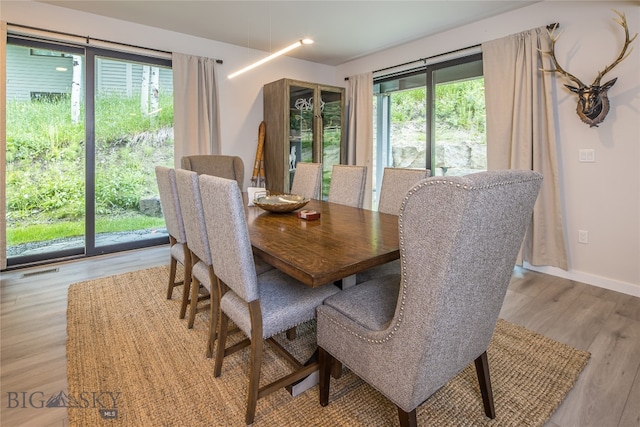 dining area featuring a healthy amount of sunlight and light hardwood / wood-style floors