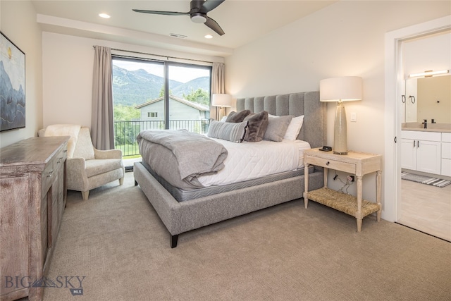 carpeted bedroom featuring connected bathroom, ceiling fan, and access to exterior