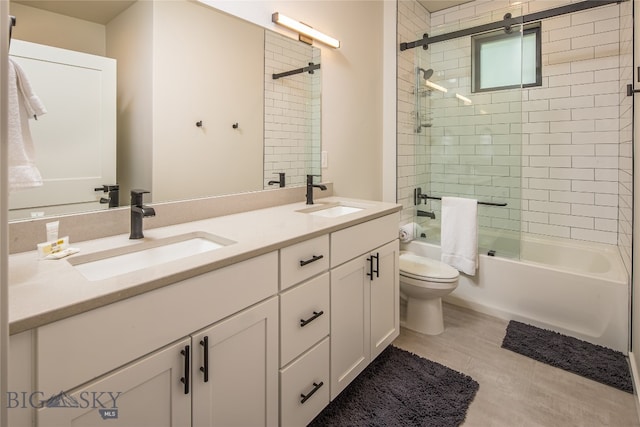 full bathroom featuring tile floors, dual vanity, tiled shower / bath, and toilet