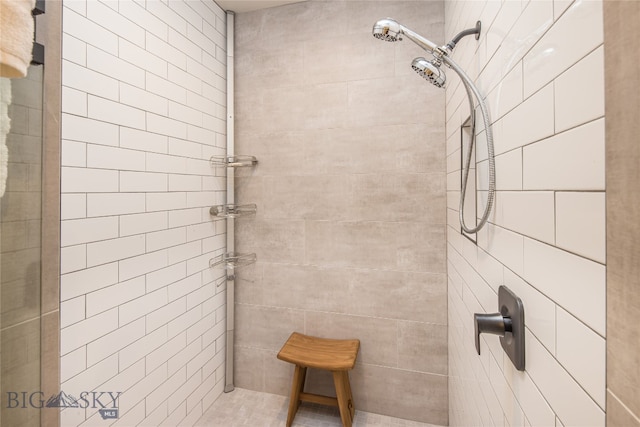 bathroom with a tile shower