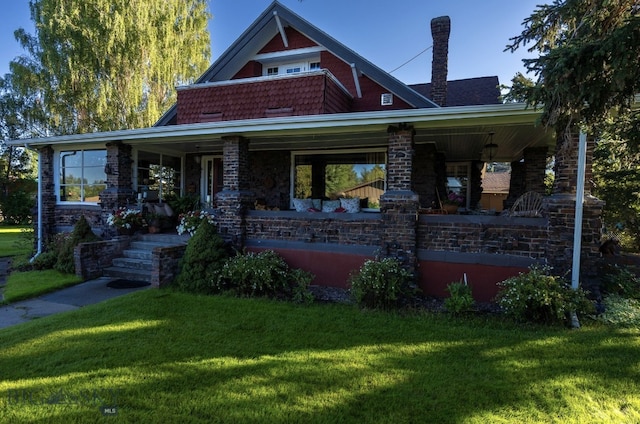 view of front of home featuring covered porch and a front yard