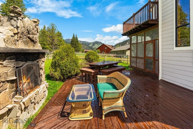 201 Silver Run Rd, Gallatin Gateway, MT 59730 - deck with an outdoor stone fireplace and a mountain view