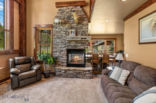 201 Silver Run Rd, Gallatin Gateway, MT 59730 - living area featuring carpet flooring, plenty of natural light, a stone fireplace, and recessed lighting