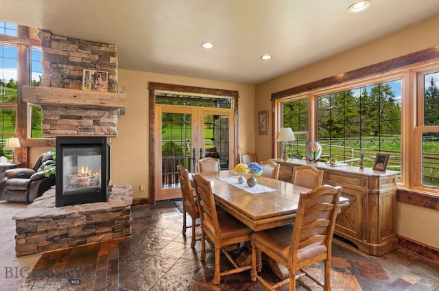 201 Silver Run Rd, Gallatin Gateway, MT 59730 - dining space with stone tile floors, french doors, recessed lighting, baseboards, and a fireplace