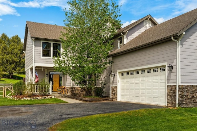 view of front of house featuring a front yard and a garage