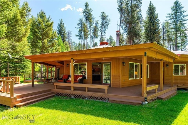 back of house with a deck, an outdoor hangout area, and a yard