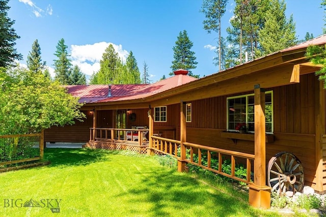 rear view of property featuring a yard