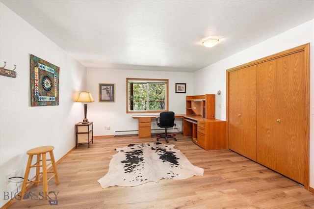 sitting room featuring a baseboard heating unit and light hardwood / wood-style floors