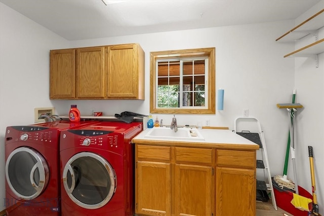 laundry area featuring sink, washing machine and clothes dryer, hookup for a washing machine, and cabinets