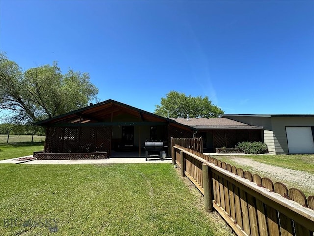 exterior space with a lawn and fence