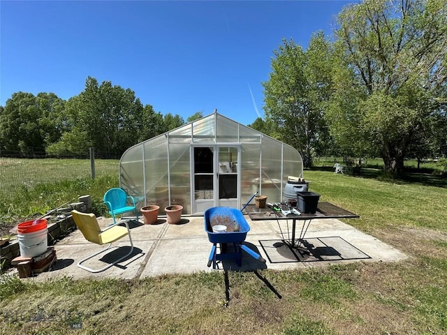 view of greenhouse with a yard