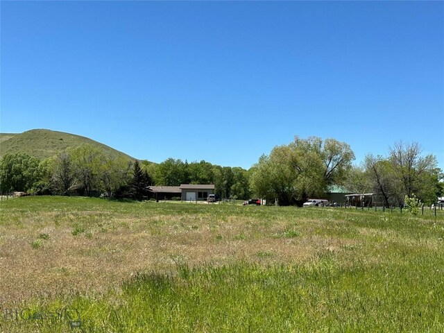 view of yard with a mountain view and a rural view