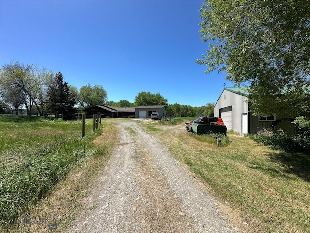 view of street featuring dirt driveway