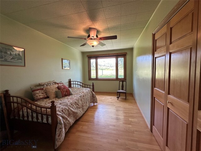 bedroom featuring light hardwood / wood-style flooring and ceiling fan