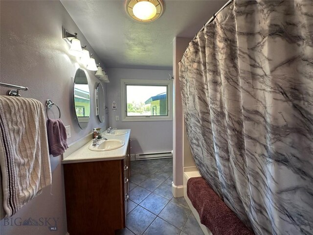 bathroom featuring a sink, tile patterned flooring, a baseboard heating unit, and curtained shower