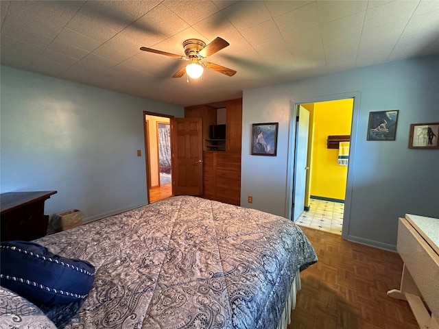 bedroom with dark parquet floors and ceiling fan