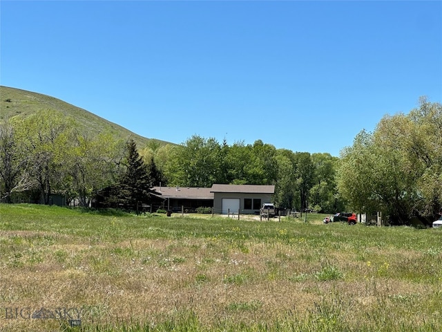 view of yard with a mountain view and a rural view