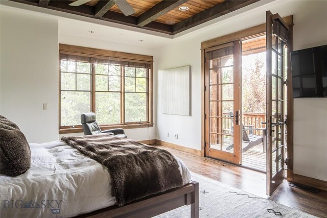 bedroom featuring french doors, access to outside, beamed ceiling, hardwood / wood-style flooring, and wood ceiling