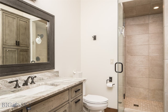 bathroom with walk in shower, toilet, and vanity