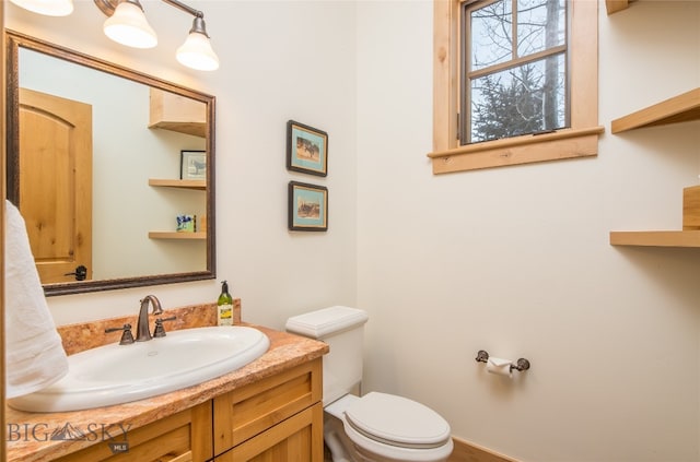 bathroom with toilet and vanity