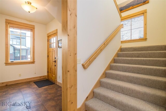 stairs featuring dark tile floors