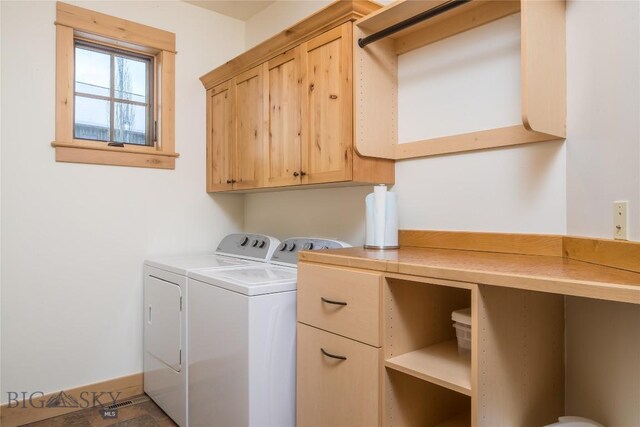 washroom featuring washer and dryer and cabinets