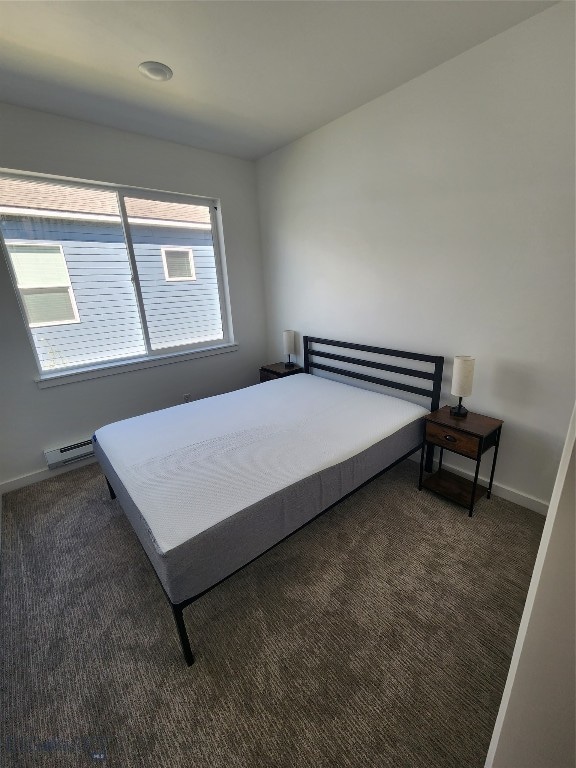 carpeted bedroom with a baseboard radiator