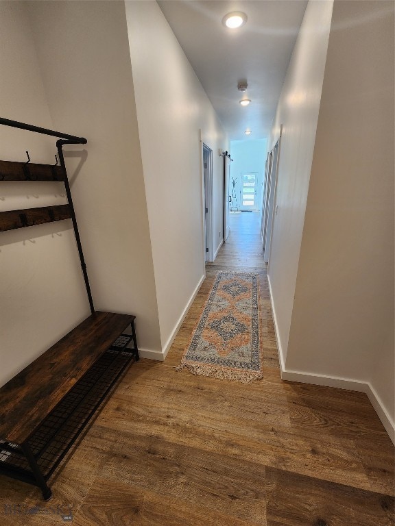 hallway with hardwood / wood-style floors