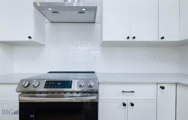 kitchen featuring white cabinetry, tasteful backsplash, and stainless steel electric stove