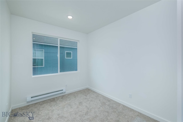 carpeted empty room with a baseboard heating unit