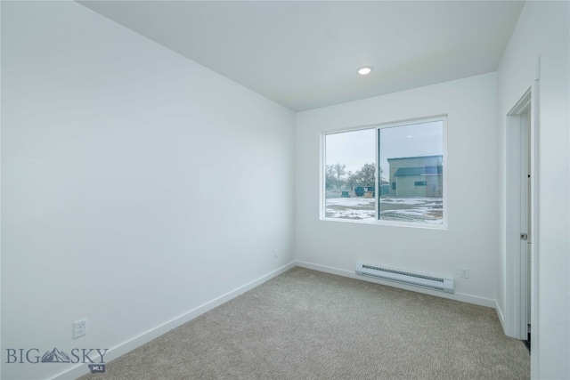 carpeted spare room featuring a baseboard radiator