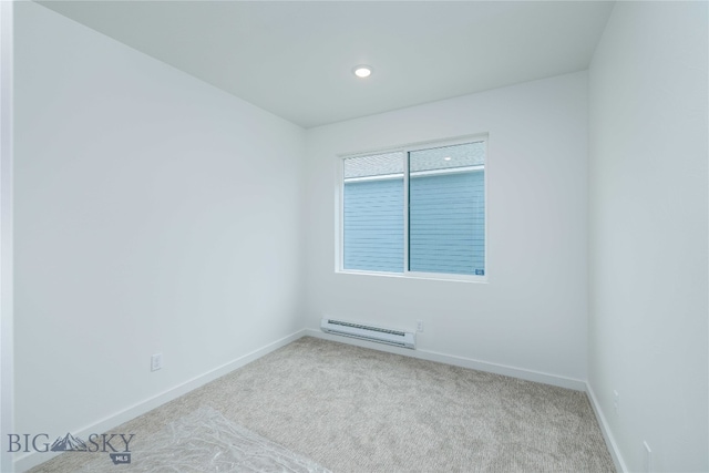 empty room with a baseboard radiator and carpet flooring