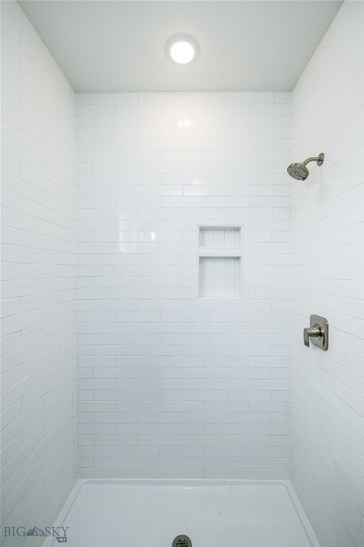 bathroom with tiled shower