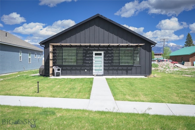 view of front facade with a pergola and a front lawn