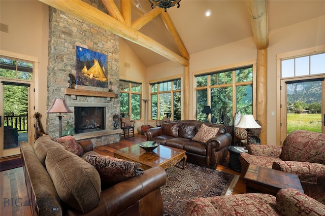 living room with beam ceiling, a fireplace, wood-type flooring, and high vaulted ceiling