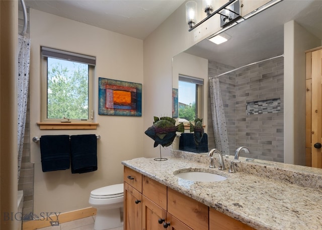 bathroom with tile patterned flooring, toilet, and vanity