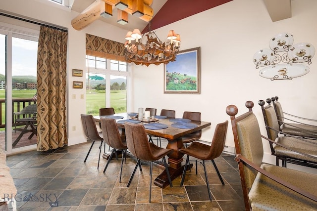 dining area with a chandelier and high vaulted ceiling