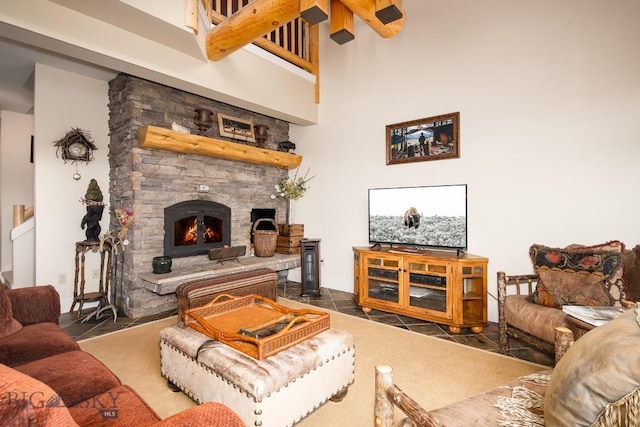 living room with a fireplace and a high ceiling