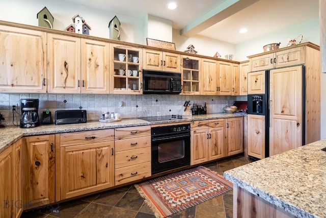 kitchen featuring black appliances, decorative backsplash, light brown cabinets, and light stone countertops