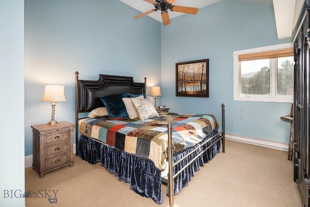 bedroom with ceiling fan, baseboard heating, light carpet, and vaulted ceiling