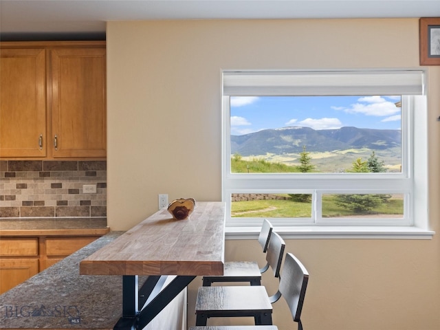 dining room featuring plenty of natural light and a mountain view