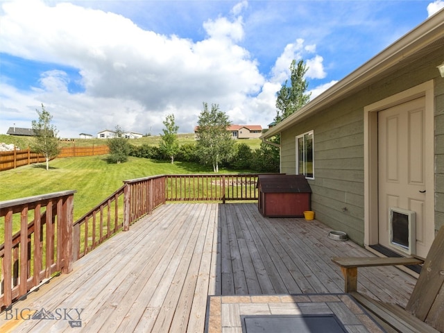 wooden terrace featuring a yard