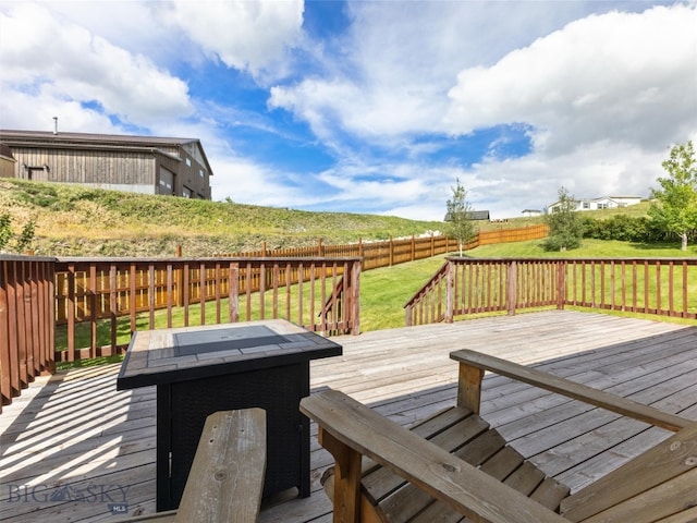 wooden terrace featuring a yard