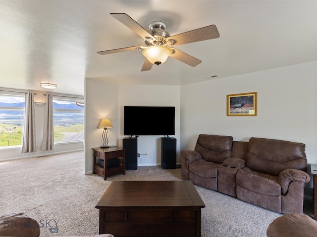 carpeted living room featuring ceiling fan