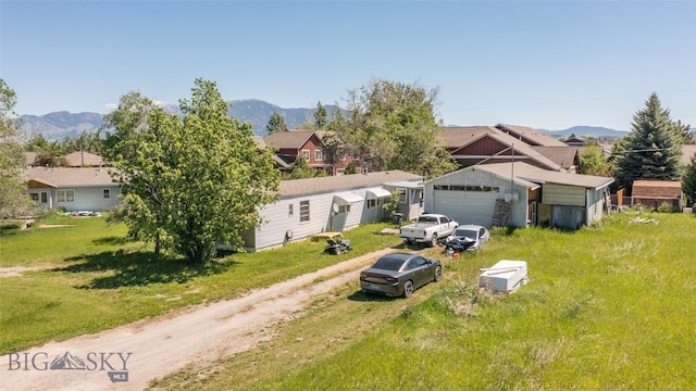 view of front of home featuring a garage, a mountain view, and an outdoor structure