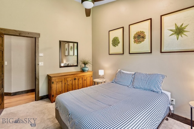 bedroom with light carpet and ceiling fan