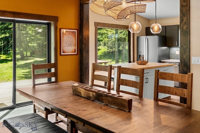 dining area with a healthy amount of sunlight and wood-type flooring