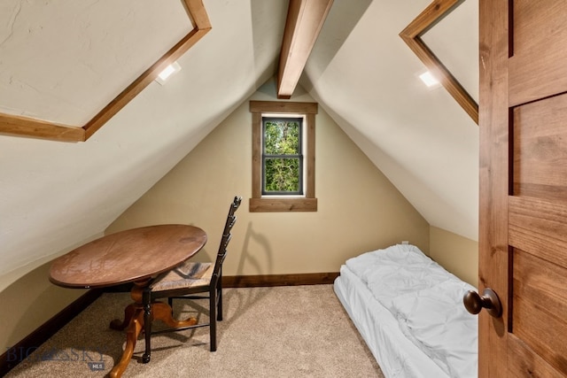 carpeted bedroom with lofted ceiling