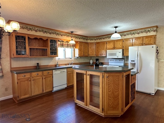 kitchen featuring a center island, dark wood-type flooring, pendant lighting, a textured ceiling, and white appliances