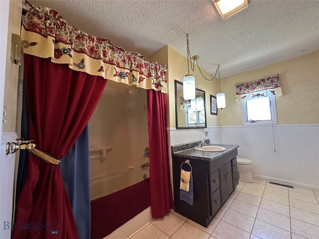 full bathroom featuring shower / bath combo, wood walls, a textured ceiling, toilet, and vanity